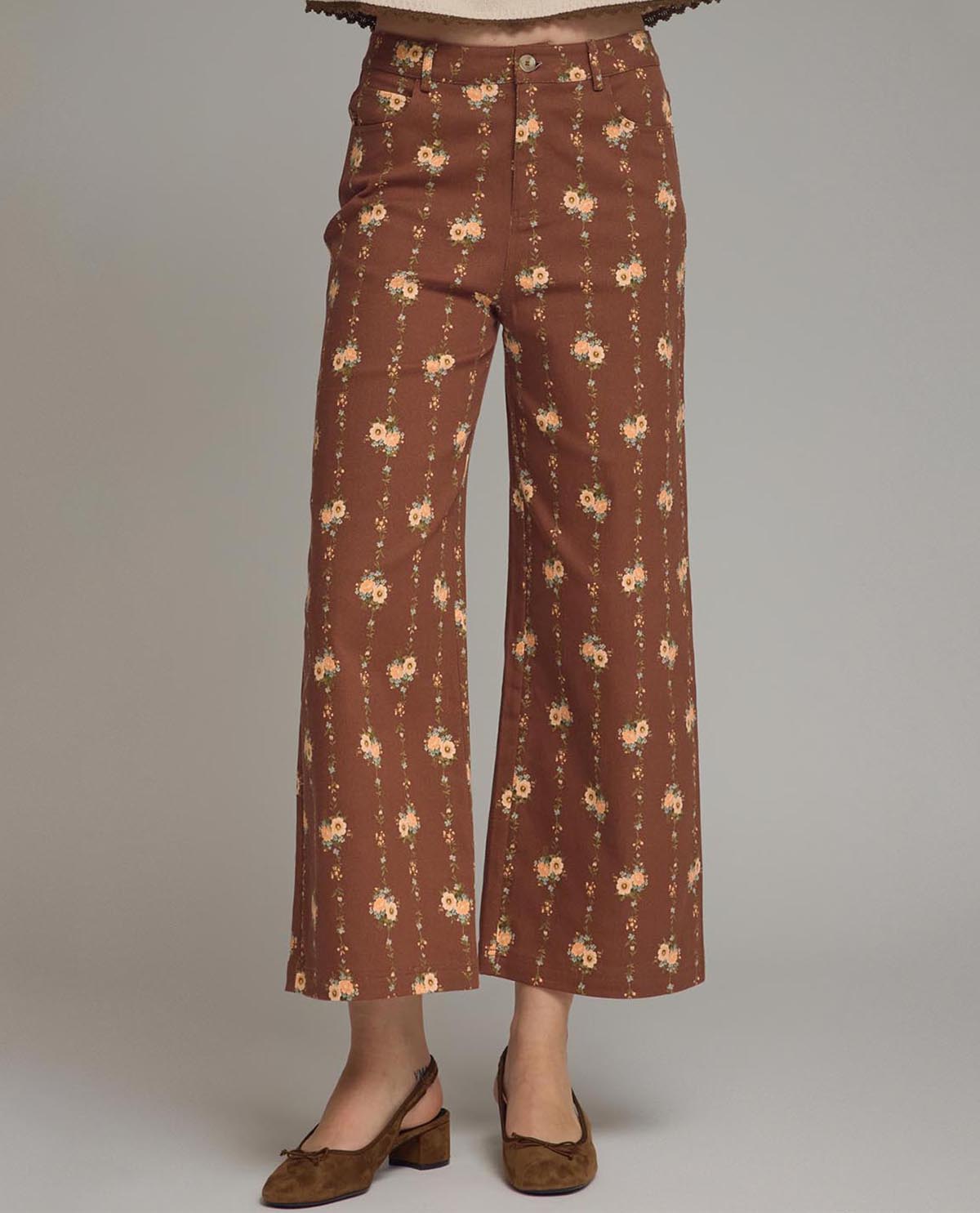 Brown floral-patterned pants on a plain background