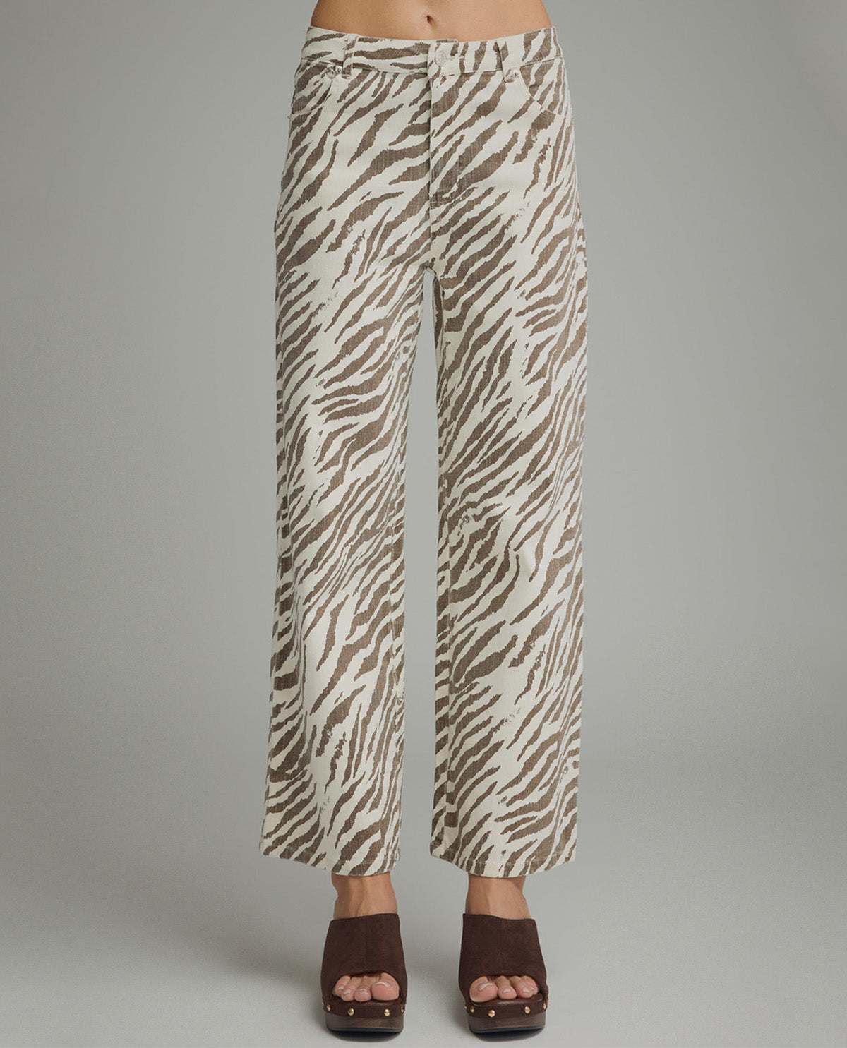 Zebra print pants worn by a person on a gray background