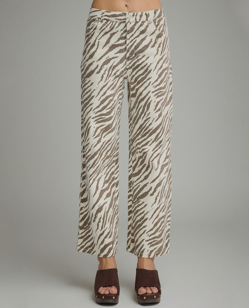 Zebra print pants worn by a person on a gray background