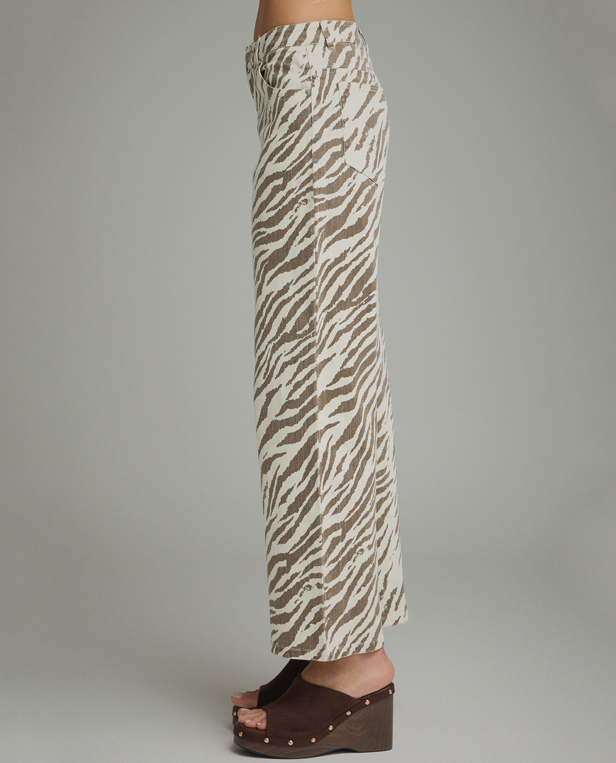 Zebra print pants worn by a person on a plain background