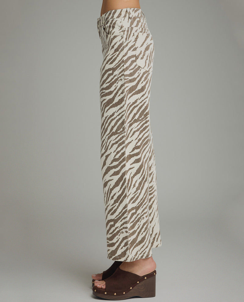 Zebra print pants worn by a person on a plain background