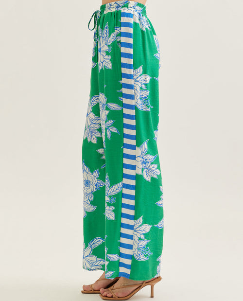 Green pants with floral and striped pattern on a white background