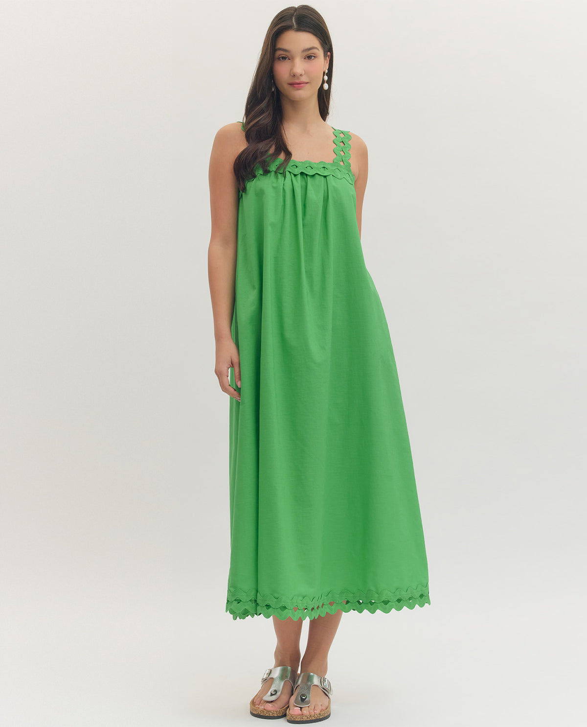 Woman wearing a green dress on a white background