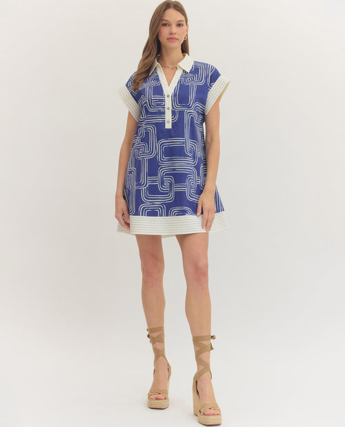 Woman wearing a blue and white patterned dress on a white background