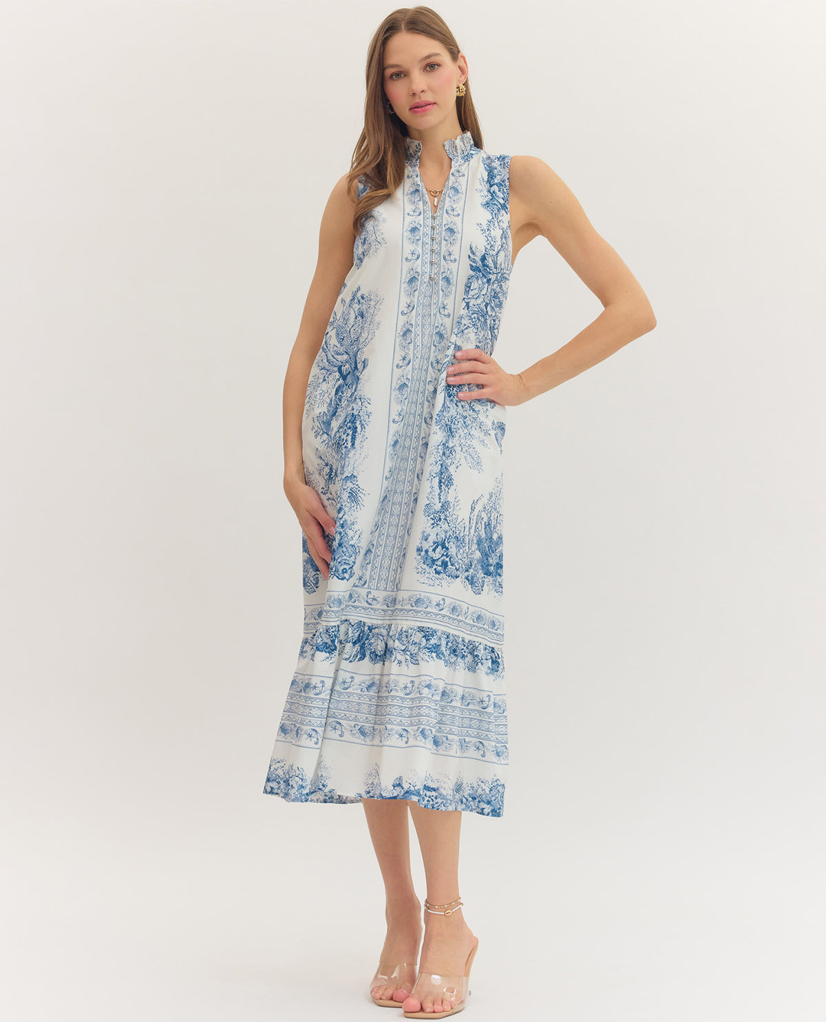 Woman wearing a blue and white floral dress on a white background