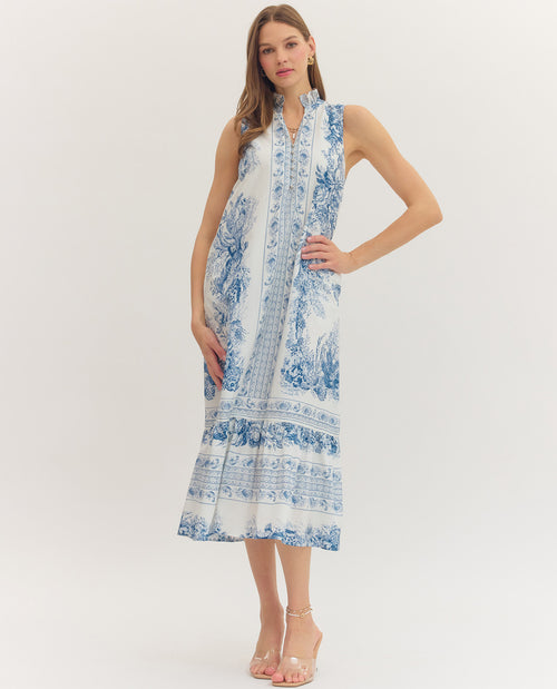 Woman wearing a blue and white floral dress on a white background