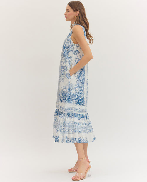Woman wearing a blue floral dress on a white background