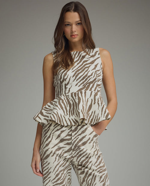 Model wearing a zebra print top and pants on a gray background