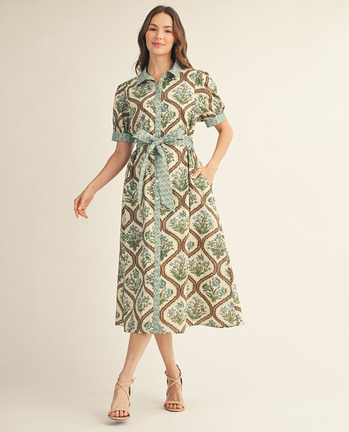 Woman wearing a patterned dress on a plain background