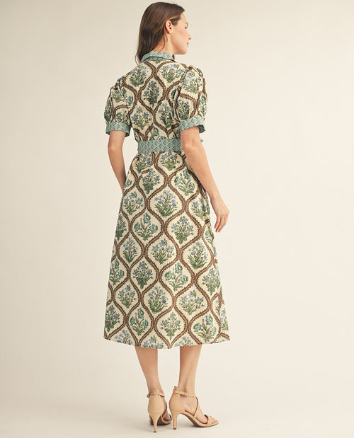 Woman wearing a patterned dress on a beige background