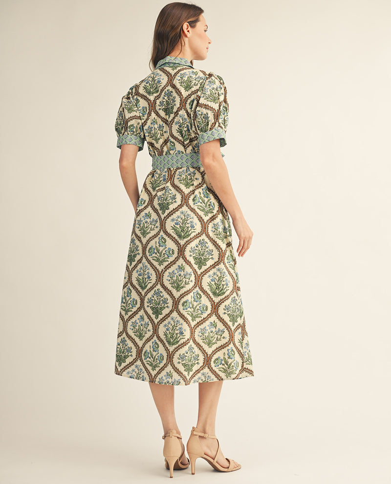 Woman wearing a patterned dress on a beige background