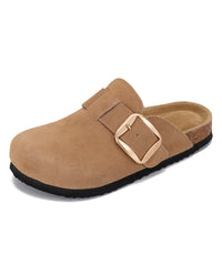 A tan suede clog-style mule shoe with a wide strap and a large rectangular buckle, shown on a plain white background.