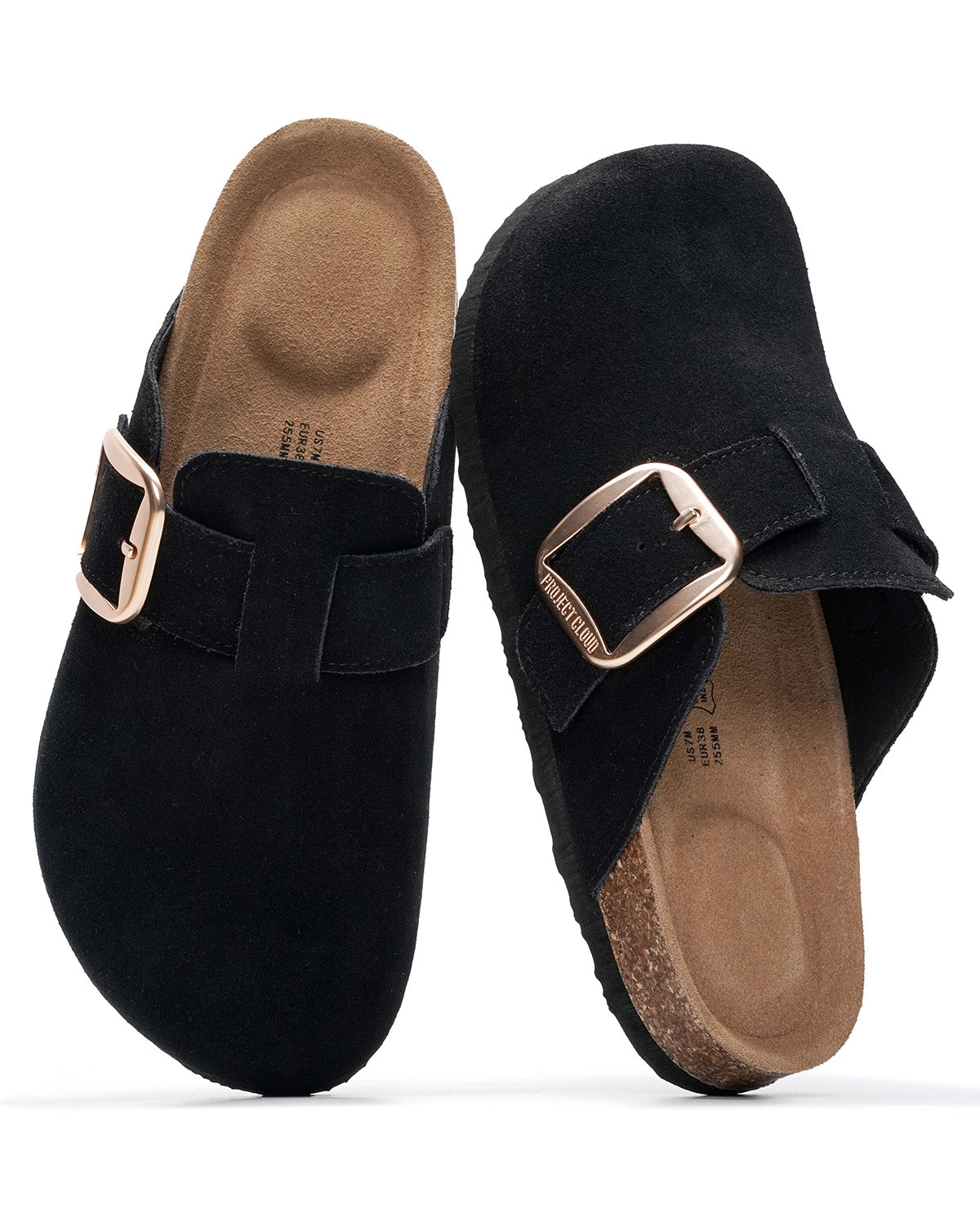A pair of black suede clogs with buckle straps and tan cork-look footbeds, shown on a white background.