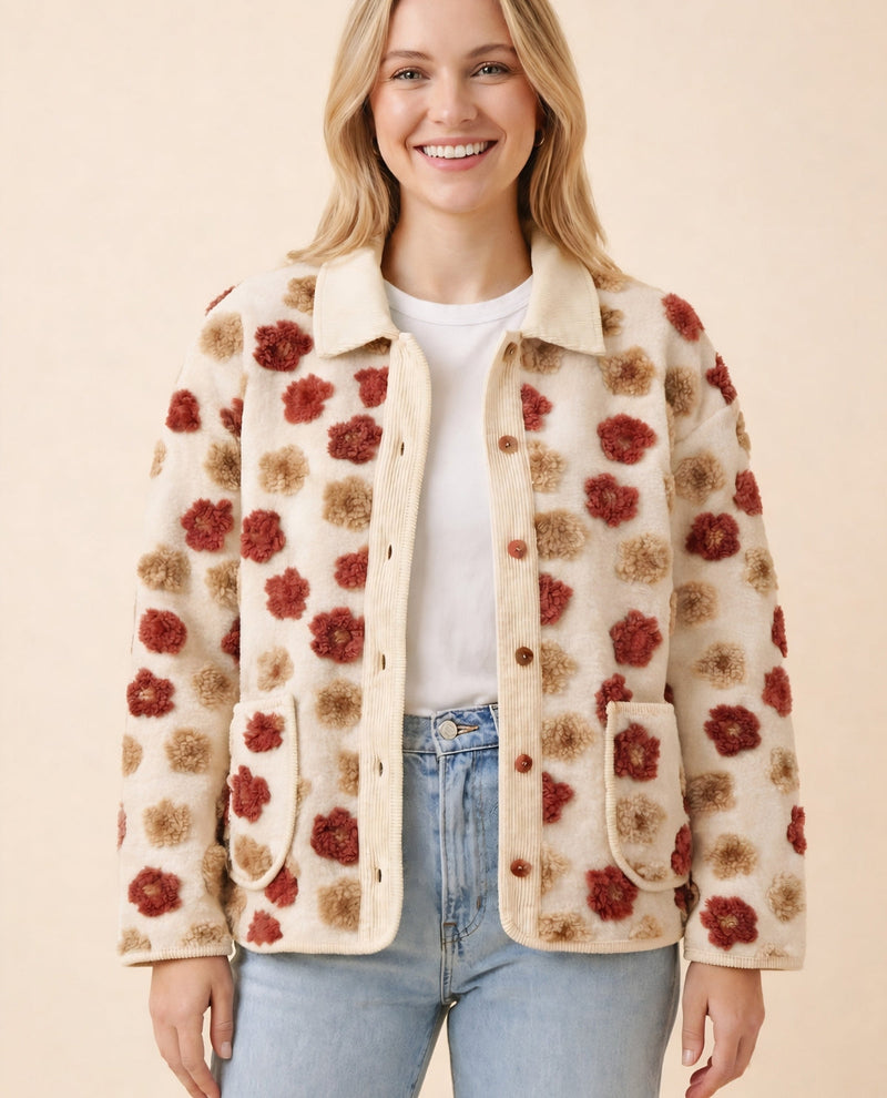 Woman wearing a floral patterned jacket on a beige background