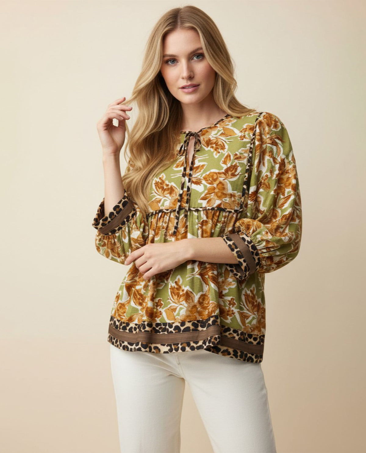 Woman wearing a patterned blouse with a beige background