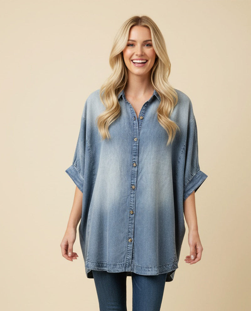 Woman wearing a blue denim shirt against a beige background