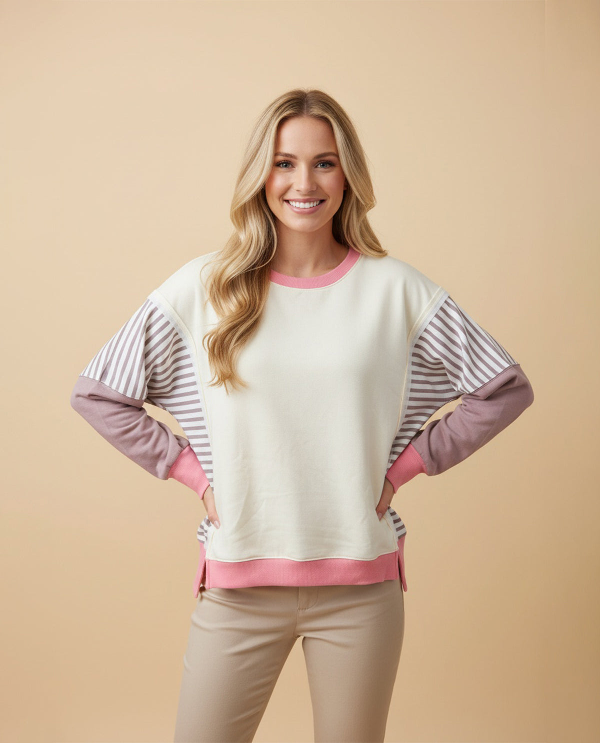 Woman wearing a colorful sweater with a beige background