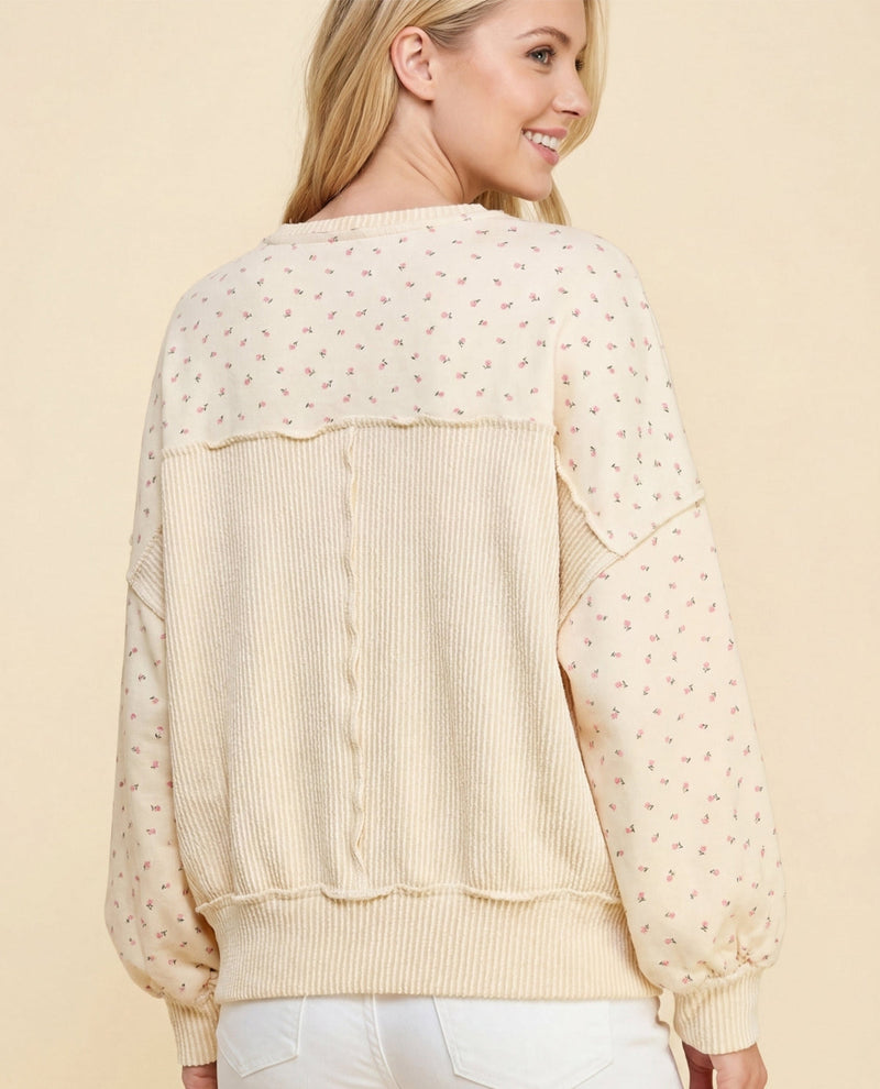 Woman wearing a beige sheer blouse with a plain background