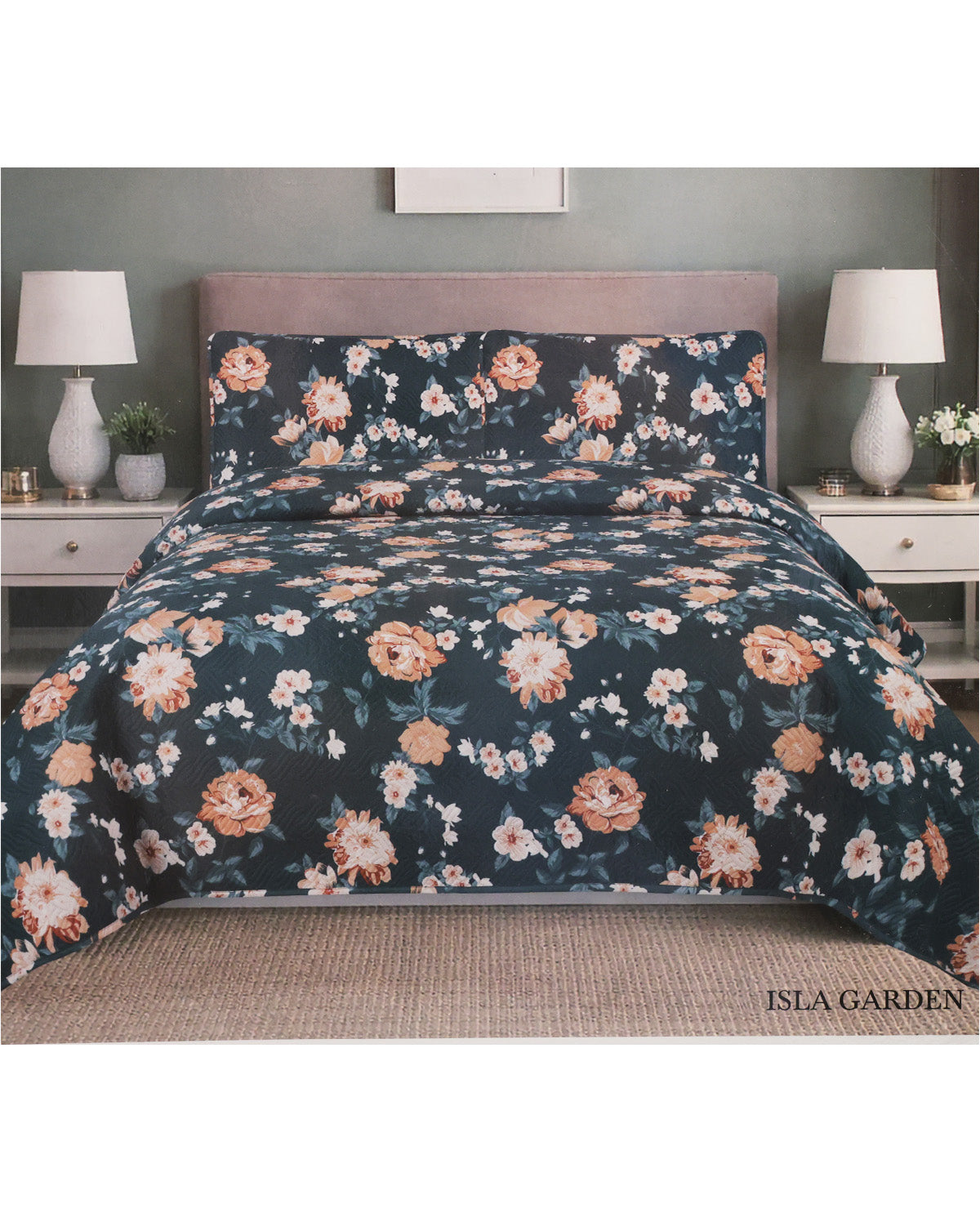 A floral bedding set with a dark navy blue background, featuring orange, peach, and white flowers with green leaves, styled on a bed with a mauve headboard in a bedroom setting. The brand name 'ISLA GARDEN' is visible in the bottom right corner.