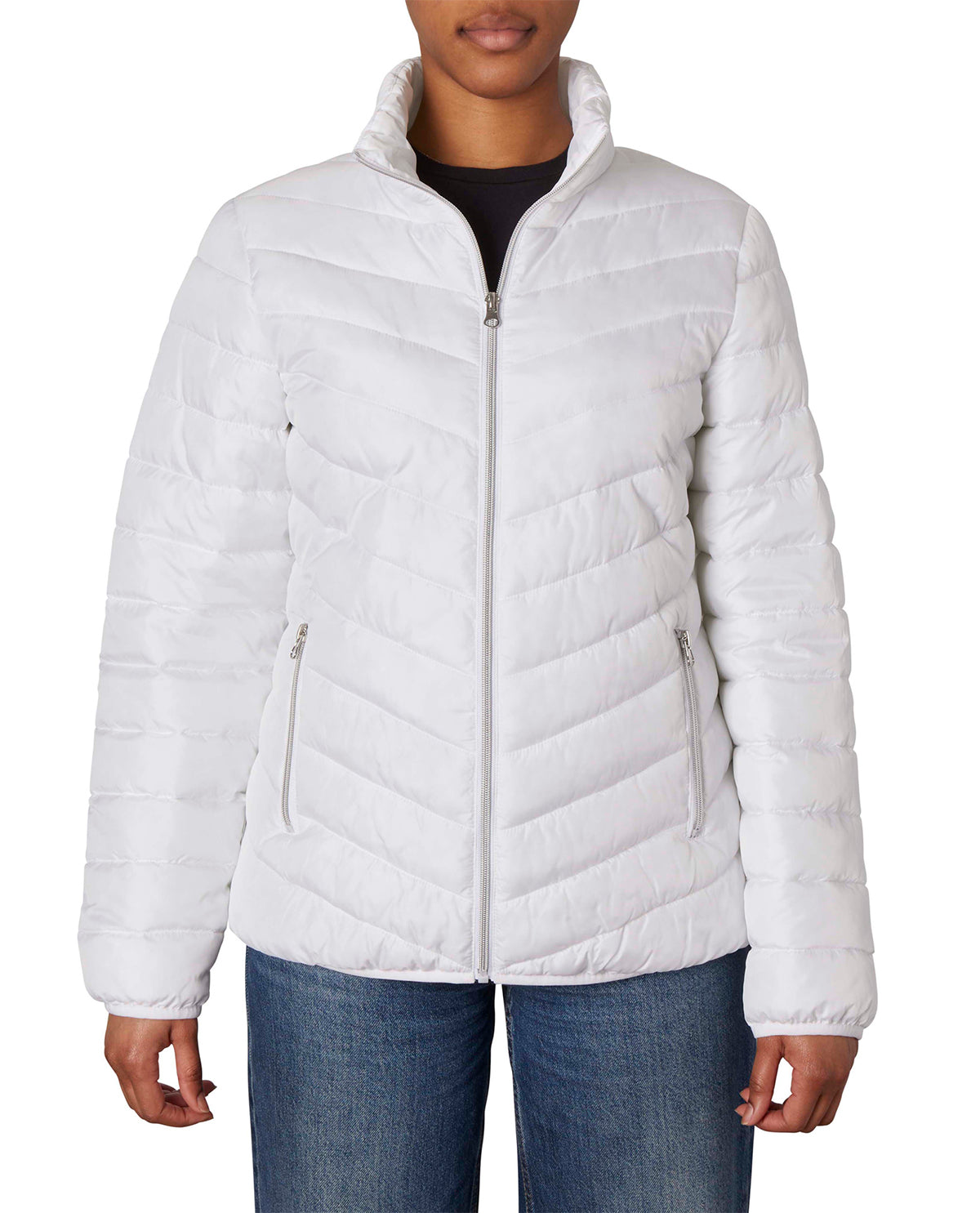 A woman wearing a white quilted puffer jacket with a stand-up collar and zippered front, paired with blue jeans against a plain white background.