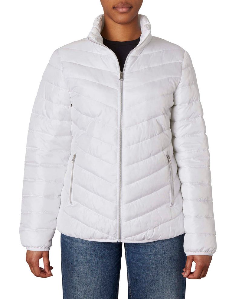 A woman wearing a white quilted puffer jacket with a stand-up collar and zippered front, paired with blue jeans against a plain white background.