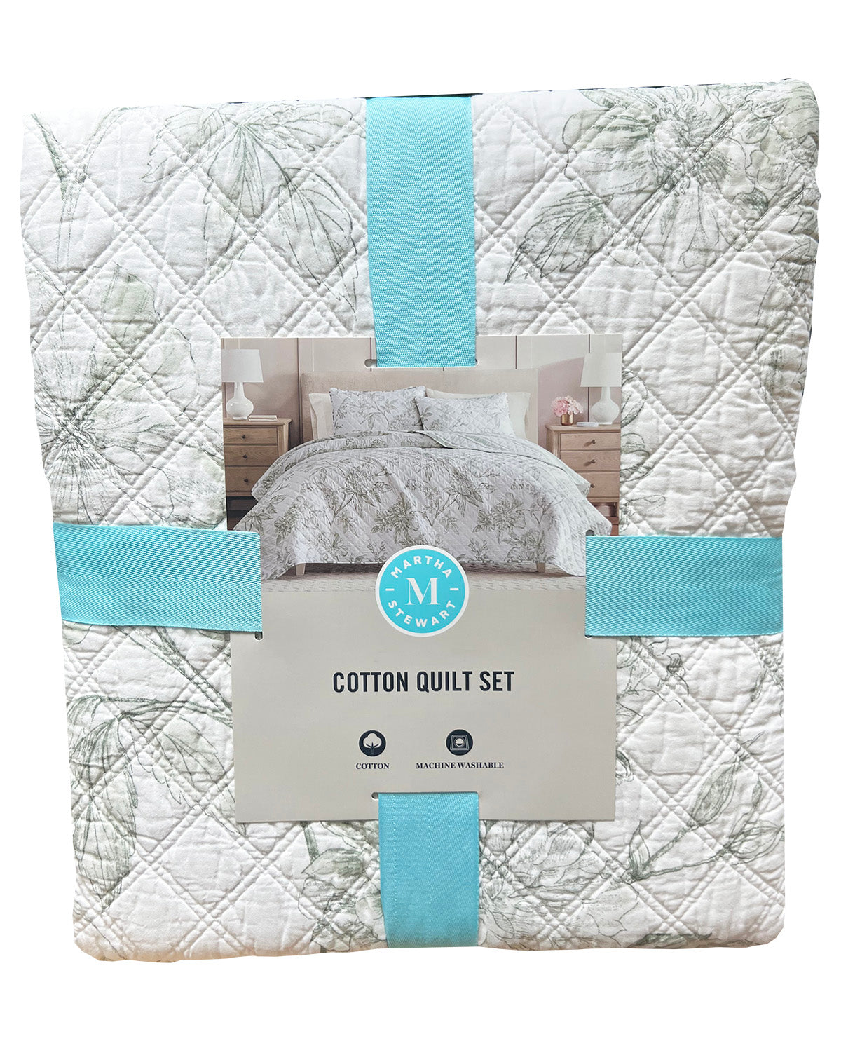 A folded cotton quilt set by M & M Collection, featuring a white quilt with a light gray botanical leaf pattern and aqua blue ribbon accents, with a central product label showing a bed setup.