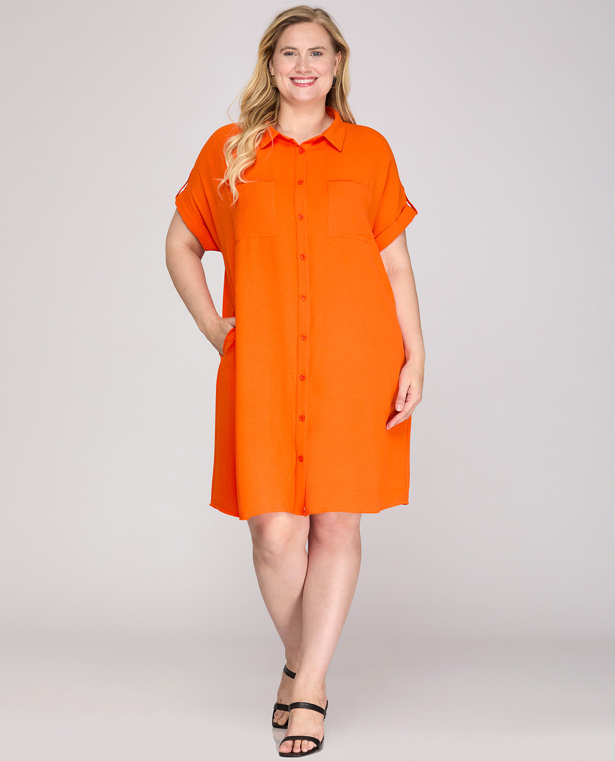 Woman wearing an orange dress on a white background