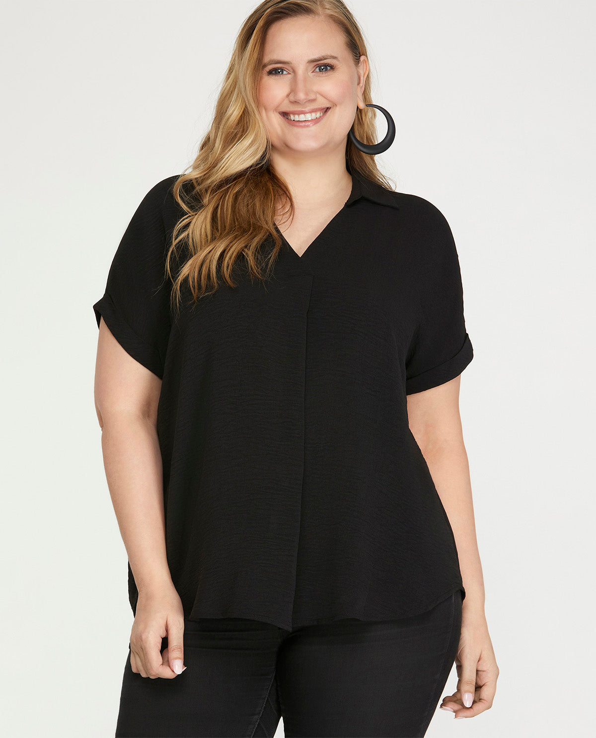 Woman wearing a black short-sleeve blouse on a white background