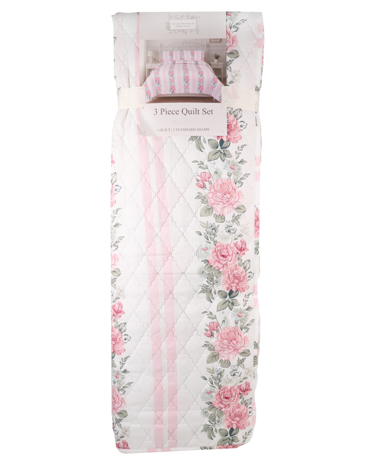A 3-piece quilt set in a soft pink and white floral print, shown folded and packaged with a paper label that reads '3 Piece Quilt Set'.