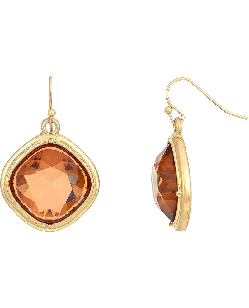 Gold earrings with orange gemstones on a white background