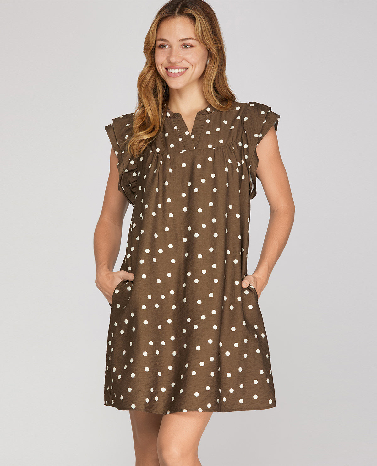 Missy model wearing a short sleeve mini brown polka dot dress