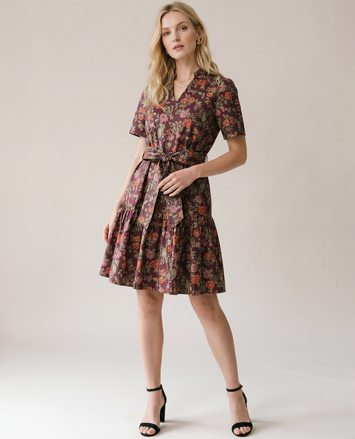 Woman wearing a floral dress on a plain background