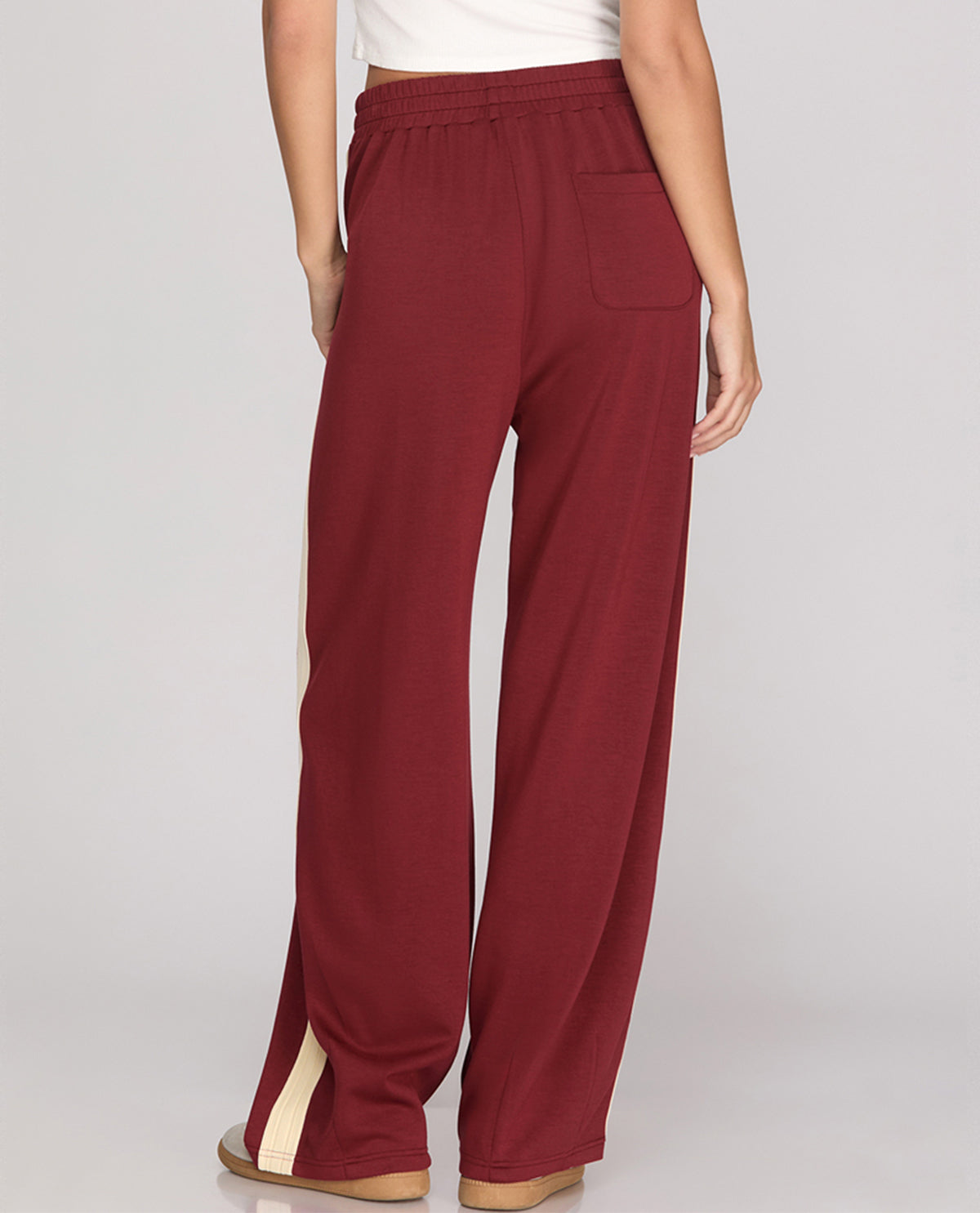 Maroon pants with a white background