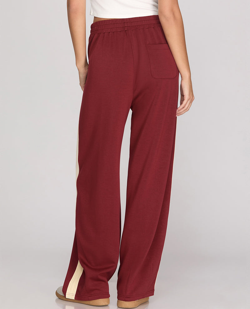 Maroon pants with a white background