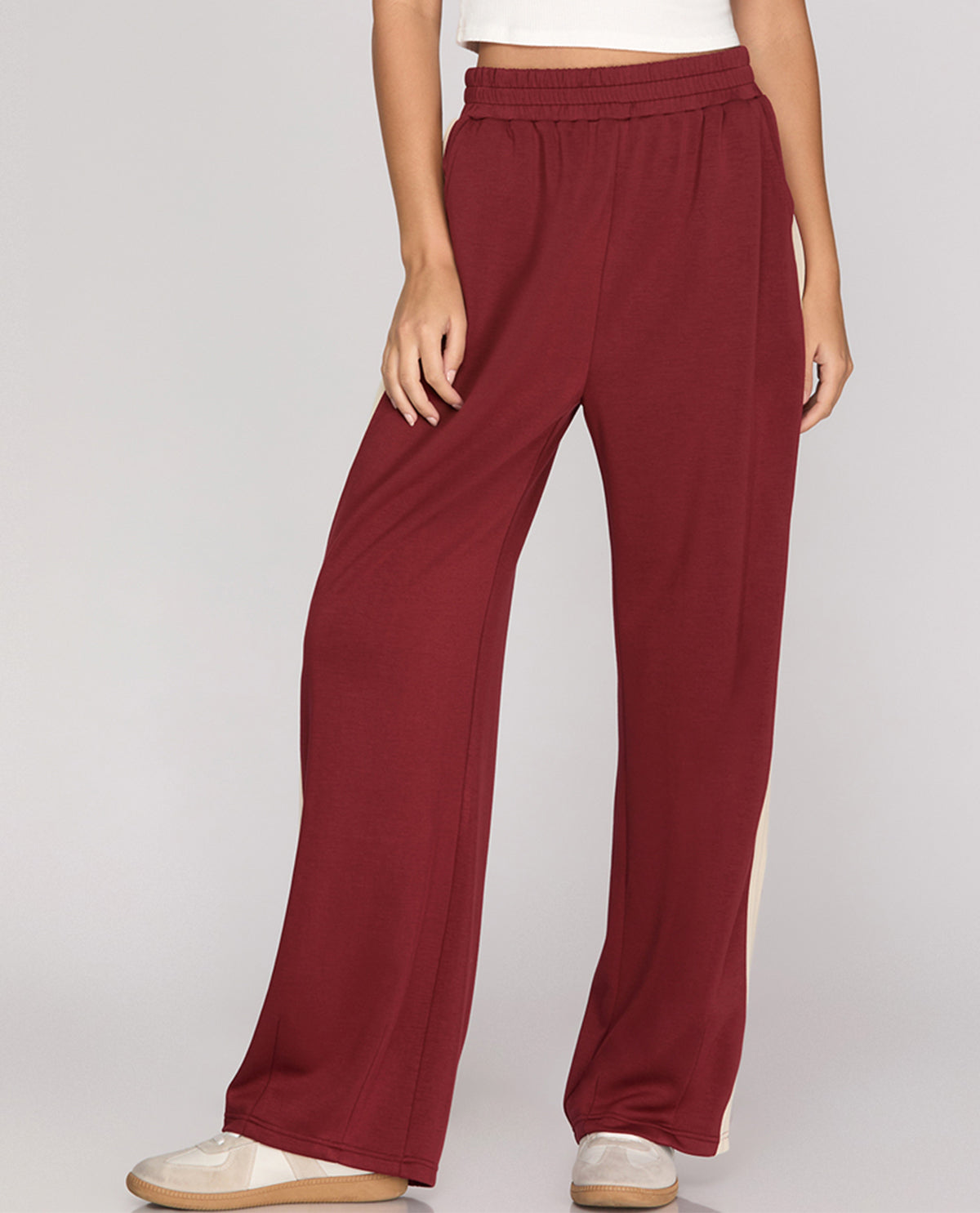 Maroon wide-leg pants worn by a person on a plain background
