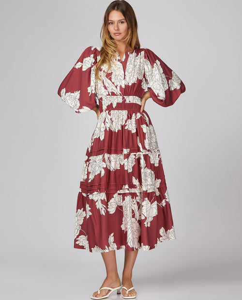 Woman model wearing a 3/4 sleeve floral midi berry dress