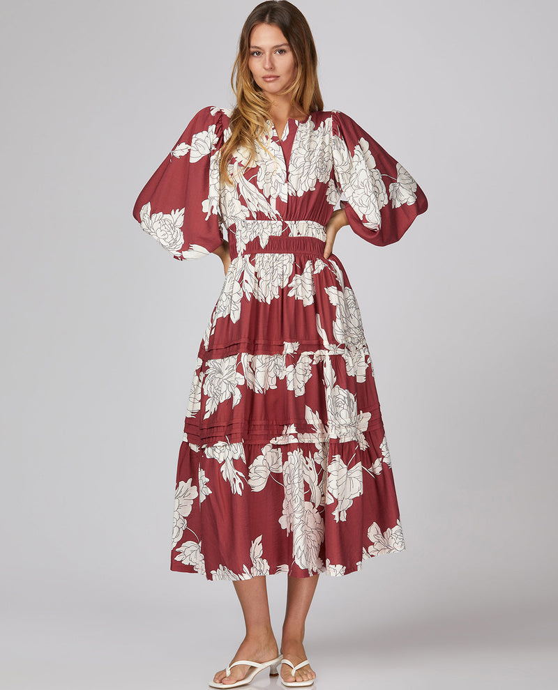 Woman model wearing a 3/4 sleeve floral midi berry dress