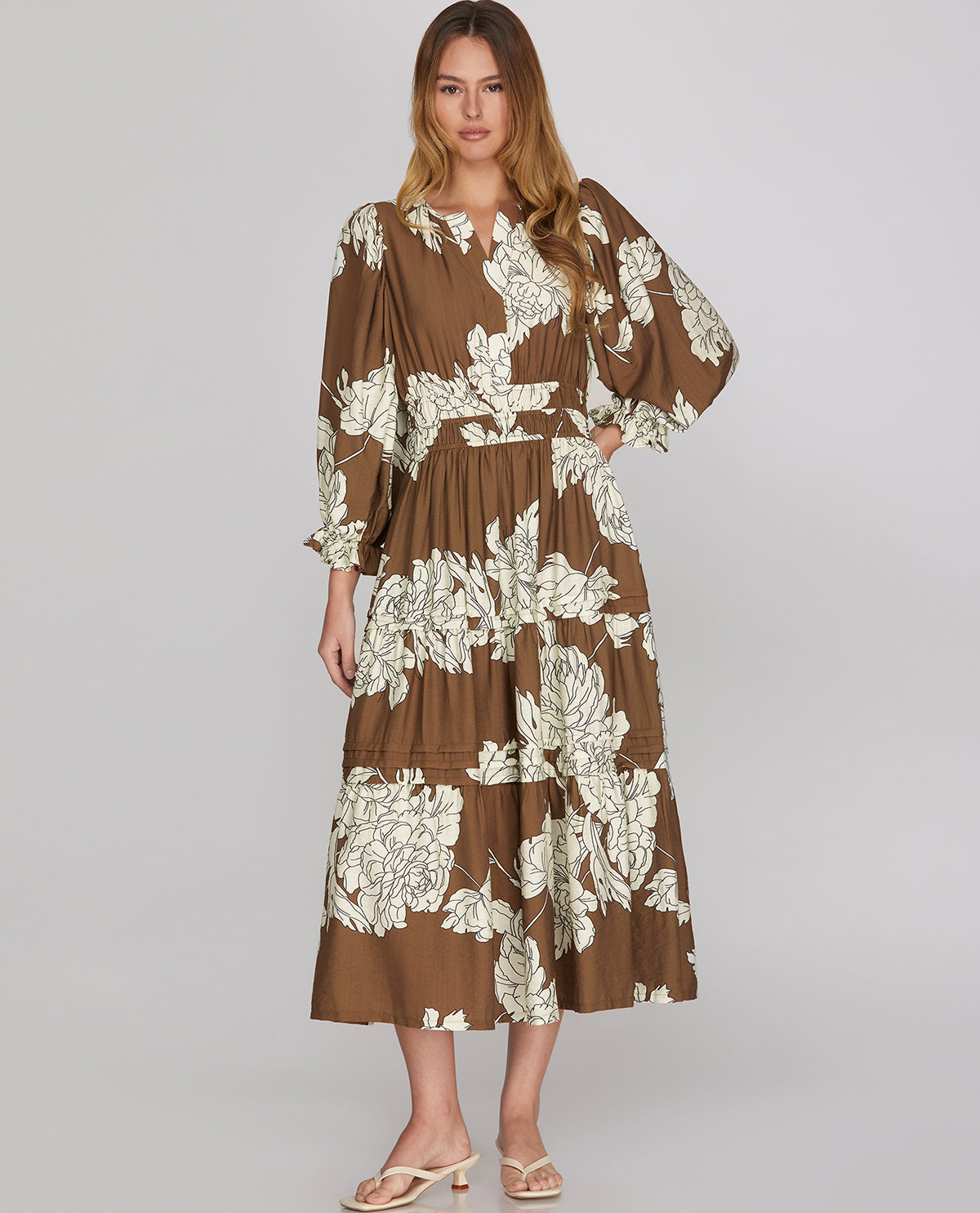 Woman model wearing a 3/4 sleeve floral midi mocha dress