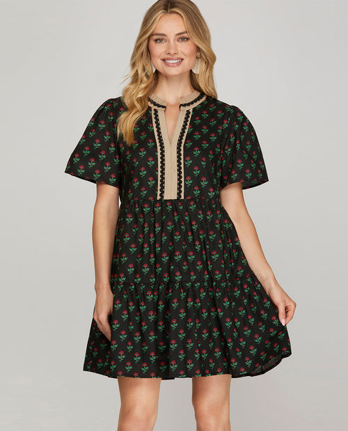 Missy model wearing a short sleeve black mini dress with contrast lace