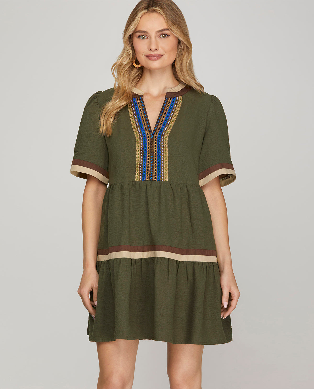 Missy model wearing a short sleeve olive mini dress with multicolor trim