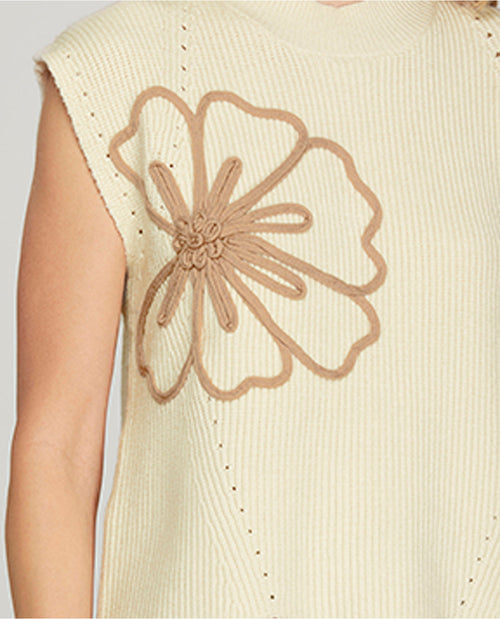 Beige sleeveless top with a large floral design on the back against a light gray background