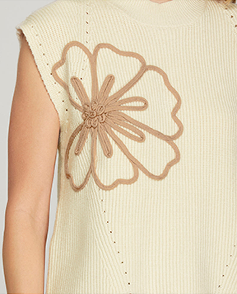 Beige sleeveless top with a large floral design on the back against a light gray background