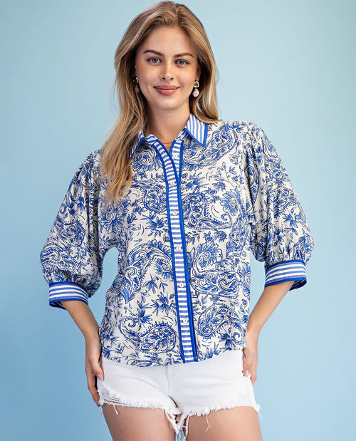 Woman wearing a blue and white patterned shirt with a blue background
