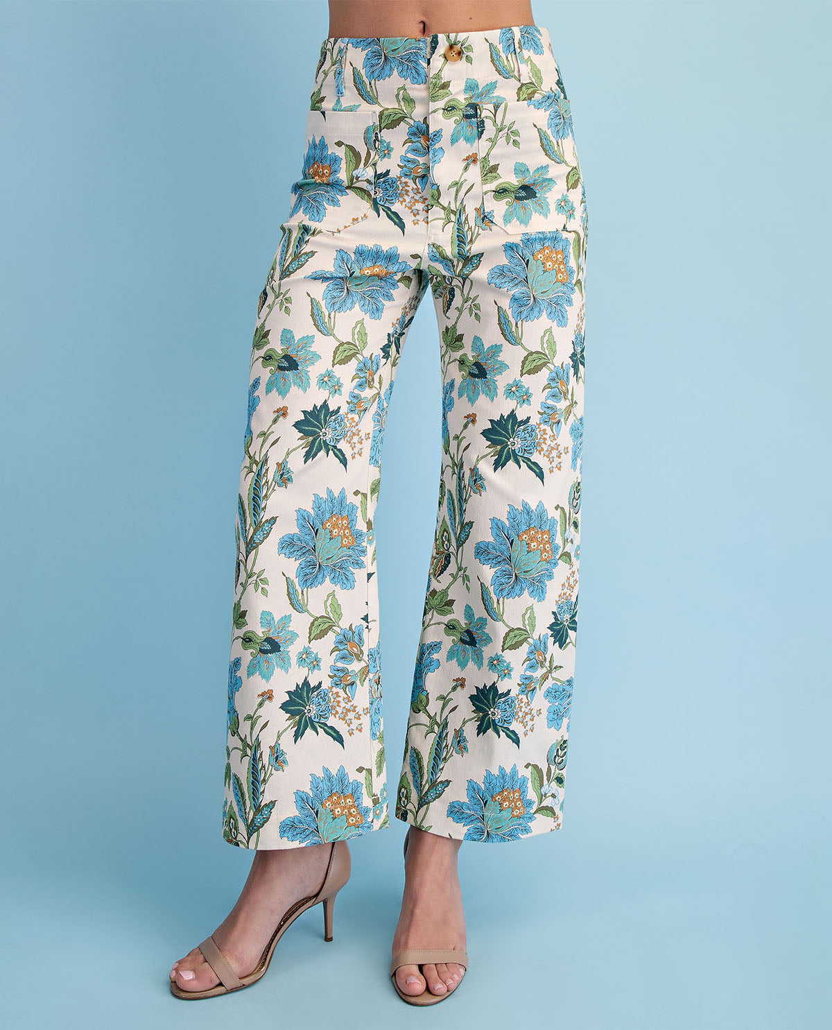 Floral pants on a model against a blue background