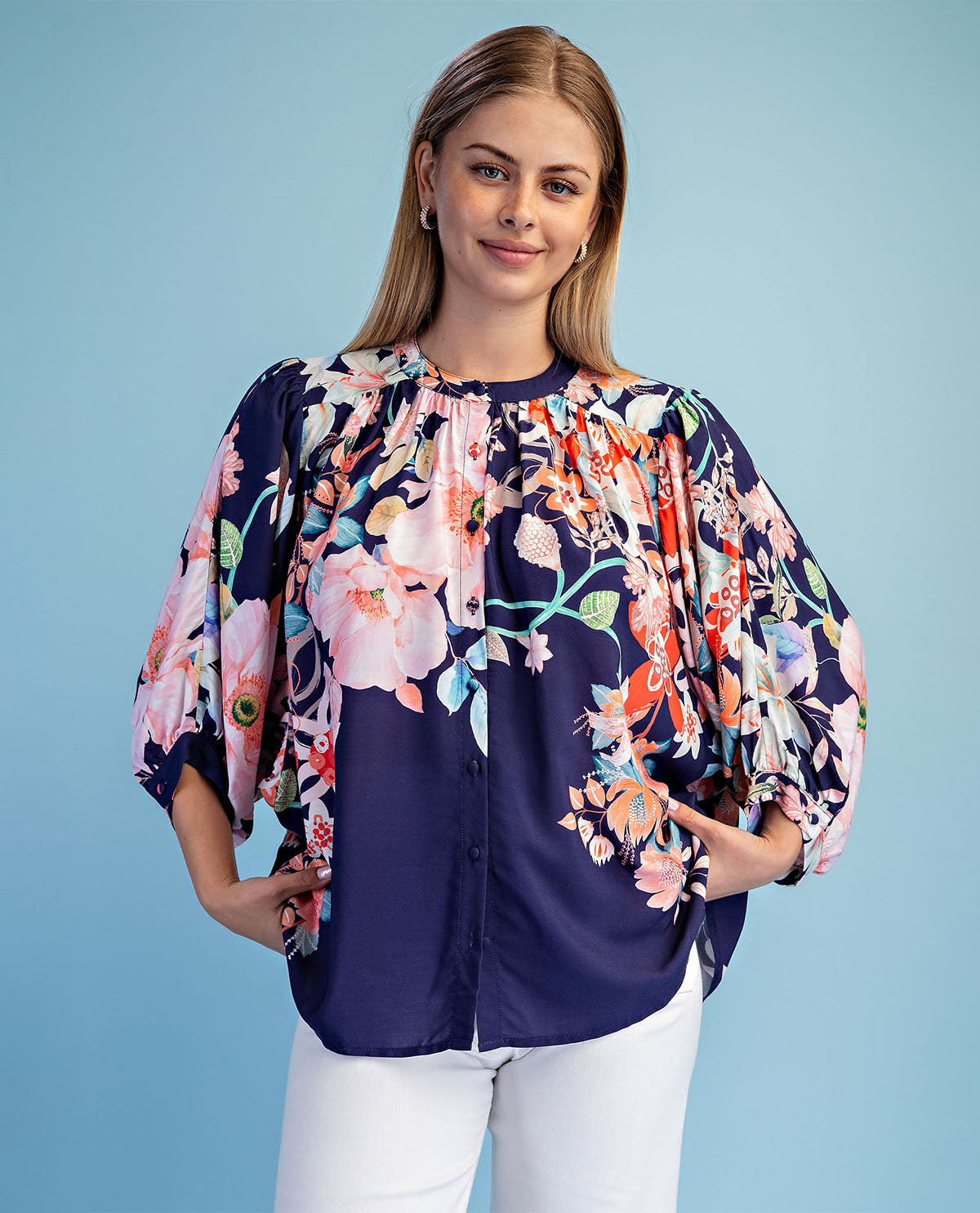 Woman wearing a floral blouse with a blue background