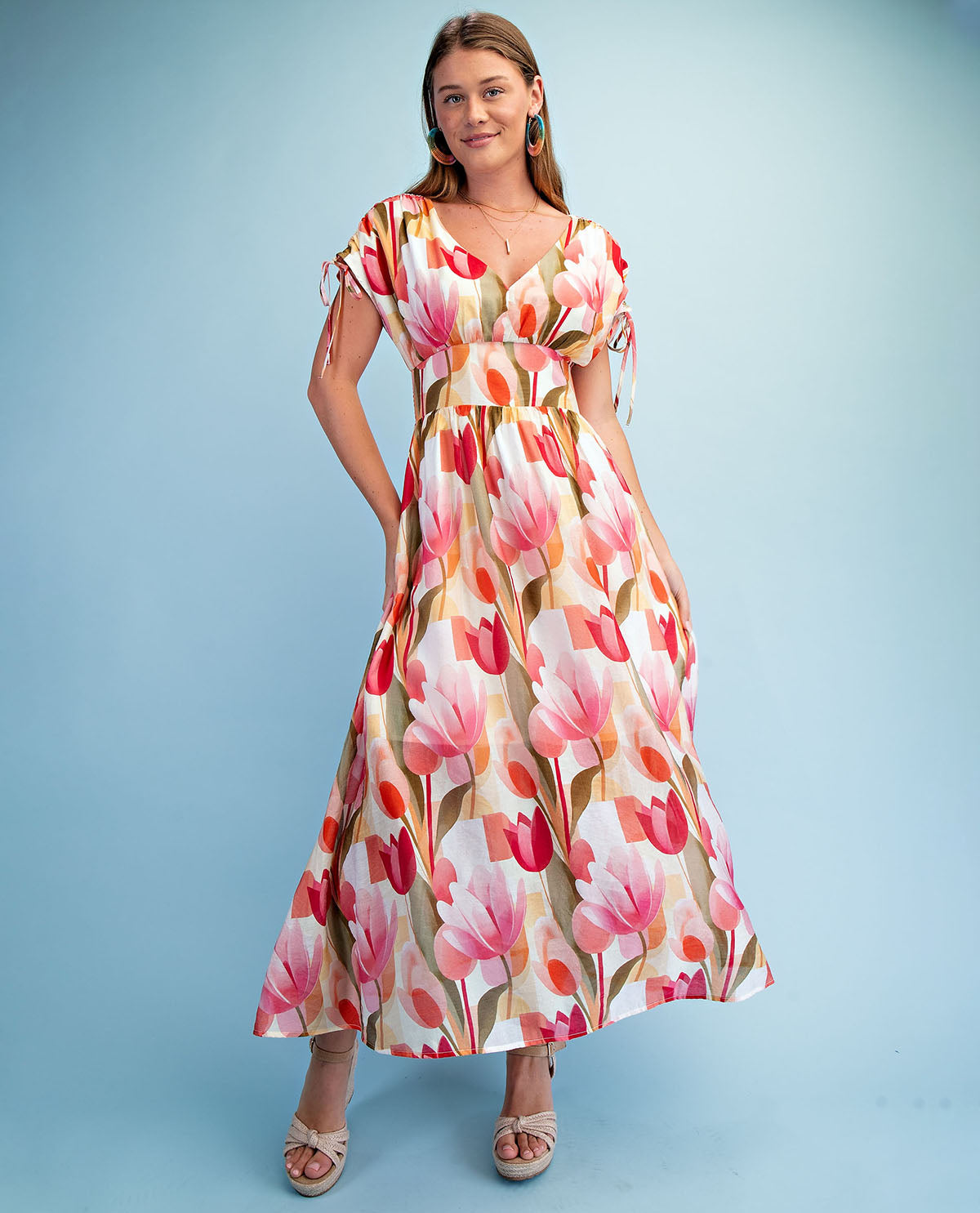 Woman wearing a floral dress against a light blue background