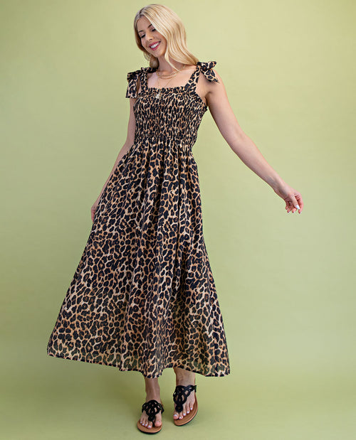 Woman wearing a leopard print dress on a green background
