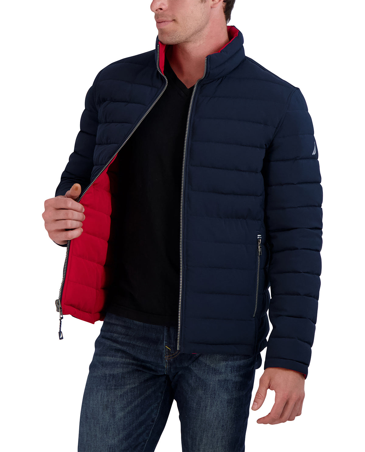 Man wearing a navy puffer jacket with red lining on a white background