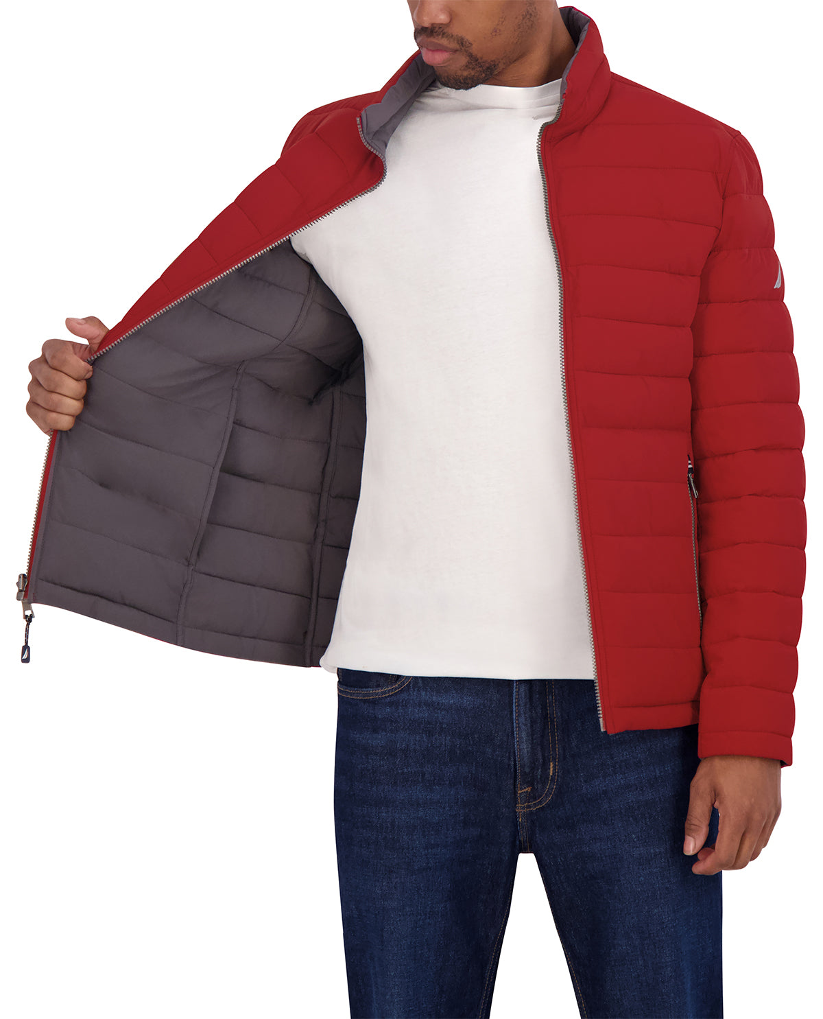 Red puffer jacket with gray interior worn by a person on a white background