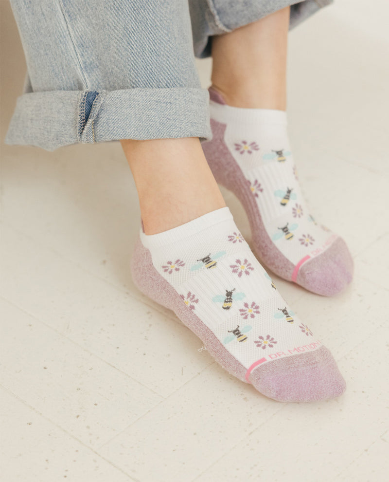 Person wearing patterned socks on a light background